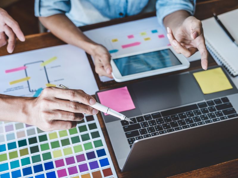 Designers looking at color swatches for a redesign
